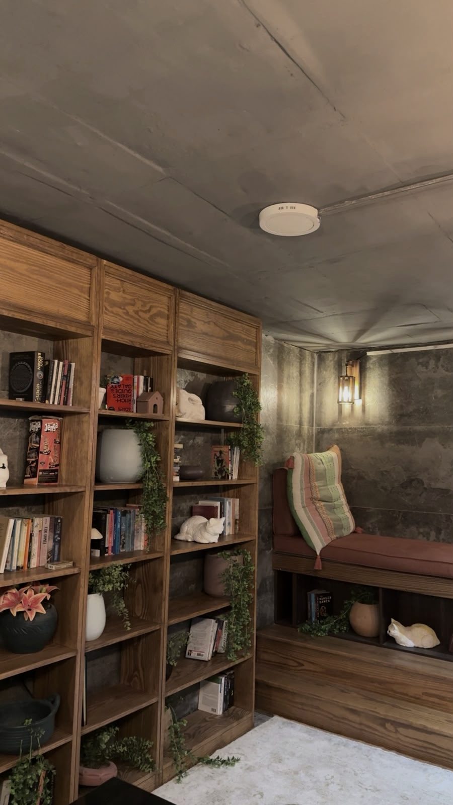 The office library — a timber bookcase and a cushioned reading nook